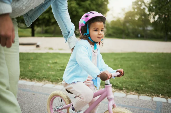 Mother, girl and learning with bike in street, road or park for love, bonding and happy on holiday. Mom, kid and teaching, cycling and bicycle on adventure, outdoor or neighborhood for development.