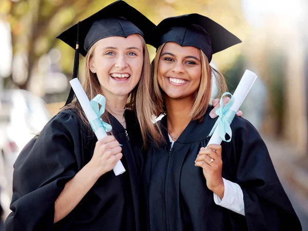 Graduation, degree and portrait of friends together happy for academic success at their university campus. Certificate, achievement and young women students with college diploma or scroll to graduate.