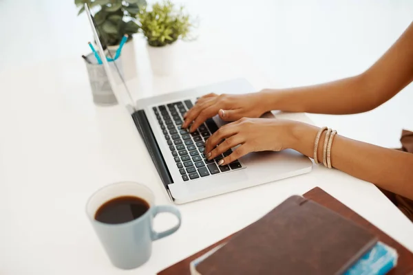 Stay connected, stay productive. a businesswoman using a laptop at her desk in a modern office