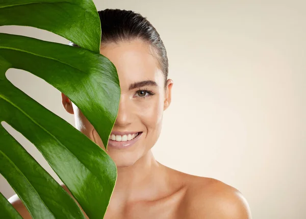 Green plant, skincare and beauty woman portrait for natural dermatology for mockup product space. Face glow skin of aesthetic model in studio for sustainable cosmetic makeup for health and wellness.