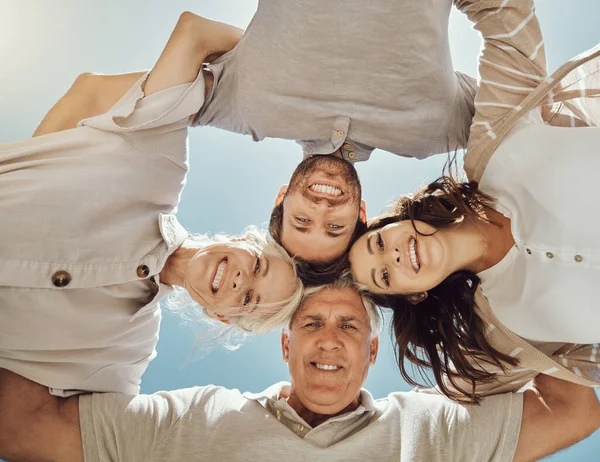 Happy family, portrait huddle and relax outdoor for travel holiday, summer vacation or comic support. Love, calm peace and happiness face together with blue sky background for sunshine adventure.