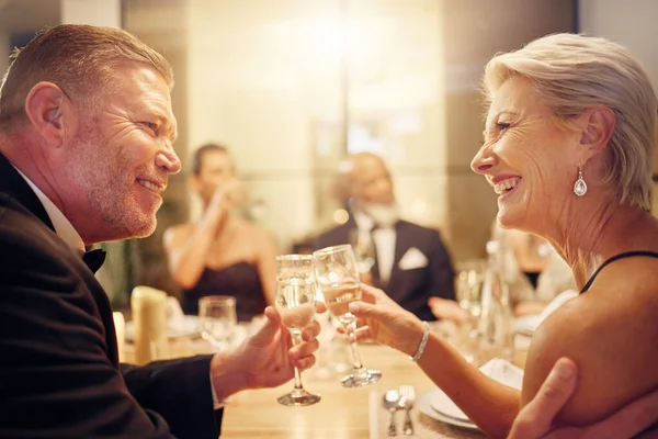Senior, party or couple of friends toast in celebration of goals or achievement at luxury social event. Motivation, funny or happy people cheers with champagne drinks or wine glasses at dinner gala.