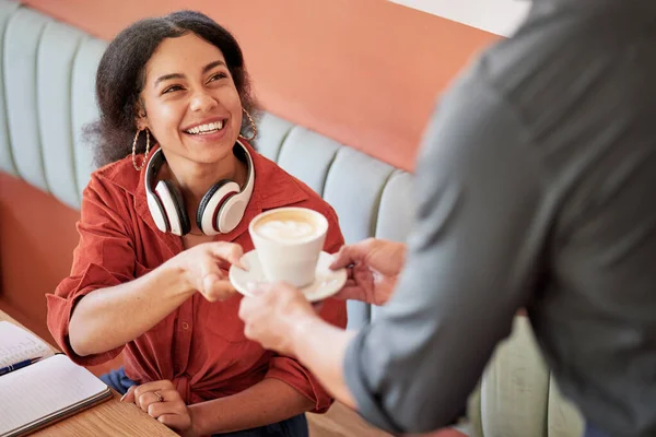 Black woman, customer and smile for coffee from waiter at cafe for happy service, thank you or caffeine. African American female remote worker smiling for cup of warm beverage at shop or restaurant.