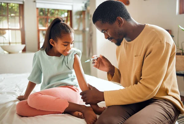 Father, girl and health vaccine in home for wellness in bedroom. Love, black family and care of man with vaccination injection for kid or child against disease, virus or flu, cold or illness in house.