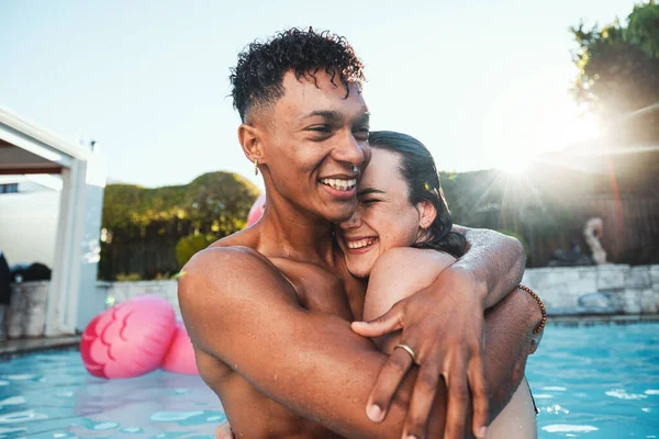 Love, pool party and couple hug, having fun and bonding together. Swimming, romance diversity and happy man and woman hugging, cuddle or laugh at funny joke in water at summer event or celebration