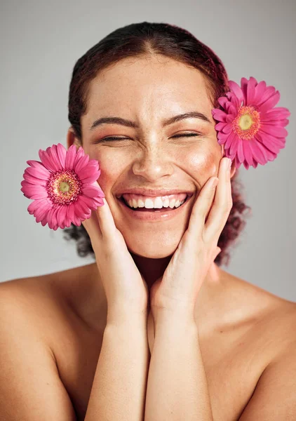 Natural beauty, flowers and face of happy woman with eco friendly makeup, facial product or floral skincare glow. Sustainable cosmetics, spa salon girl and model smile isolated on studio background.