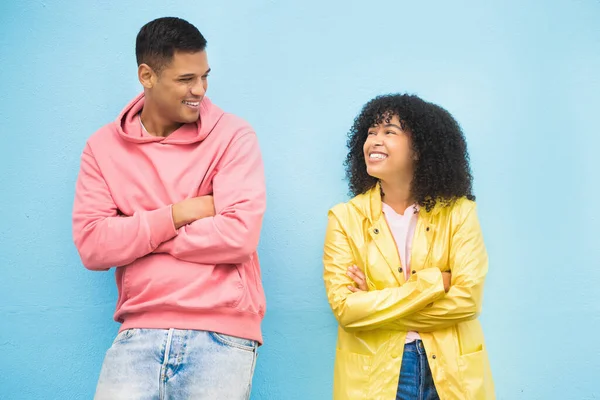 Couple of friends, happy and arms crossed on isolated blue background in city bonding, support and fun city travel. Smile, happy man or black woman and confidence, afro hair or fashion clothes mockup.
