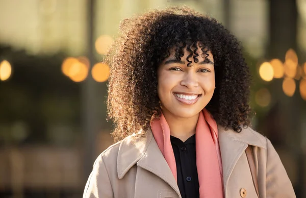 Black woman, portrait and city travel with a happy smile while outdoor on London street with freedom. Smiling face of young person with natural afro hair, beauty and fashion style during holiday walk.