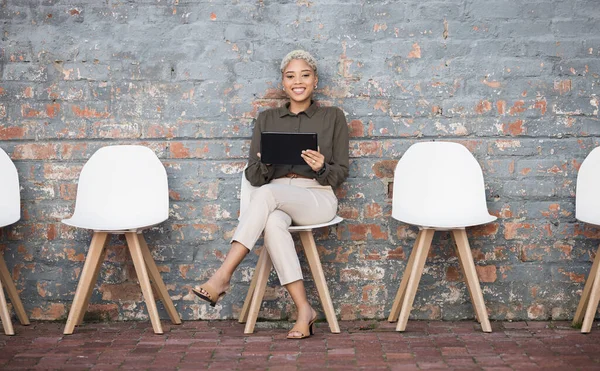 Recruitment, portrait and black woman tablet outside for job opportunity, hr and career success. Digital technology, waiting room and gen z person on social media app for we are hiring on brick wall.