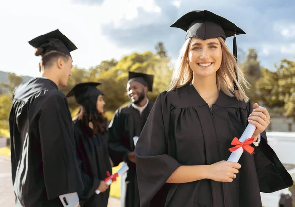 Woman, student and portrait smile for graduation, ceremony or achievement in higher education. Happy female academic learner holding certificate, qualification or degree for university scholarship.