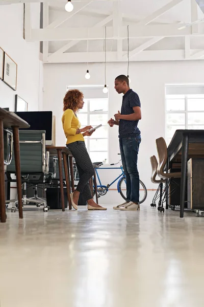 Using technology to support her pitch. two colleagues having a discussion in a modern office