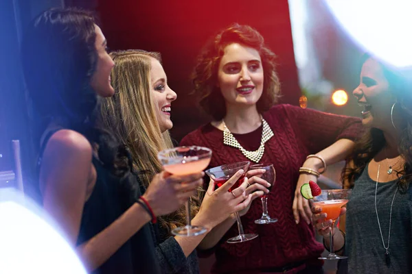 When they get together its always a special occasion. a group of young women drinking cocktails at a party