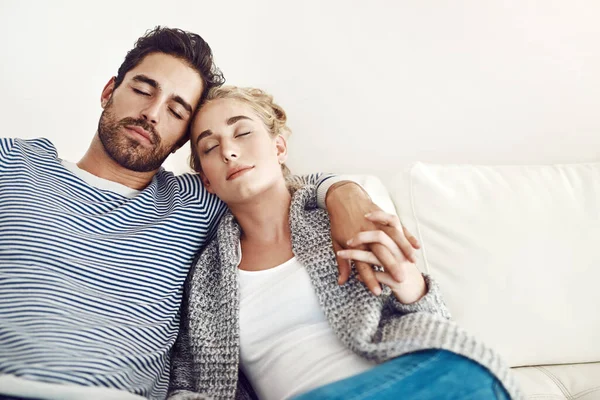 Your arms is the safest place. young couple having a nap together on their sofa at home