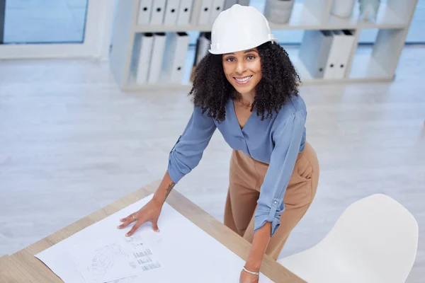 Architect, woman portrait and blueprint of engineer drawing plan on paper for building development. Happy contractor at office desk for project management, architecture and engineering mockup space.