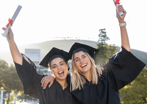 Graduation, celebration and portrait of women cheering for scholarship success. Happy female students, graduate certificate and study goals with award, smile and motivation of friends at university.