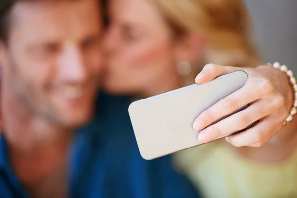 Immortalize your love. Closeup of a happy couple taking a selfie together on a phone