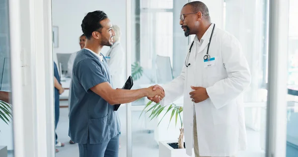 Doctor, handshake or nurse on tablet in hospital teamwork collaboration, medical research planning or surgery vision idea. Smile, happy or shaking hands healthcare workers, technology or welcome talk.