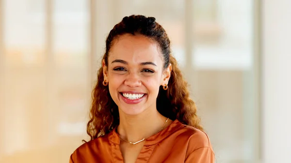 Latino business woman smiling and laughing with joy in an office. Portrait of a confident and ambitious young entrepreneur feeling motivated, empowered and optimistic for success in a startup company.