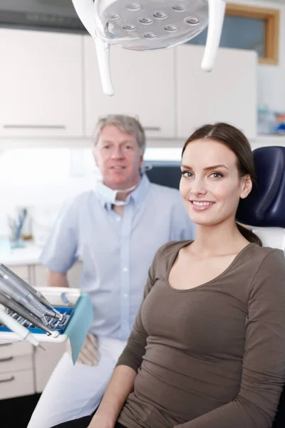 Smiling patient with dentist. Portrait of smiling female patient with dentist at clinic