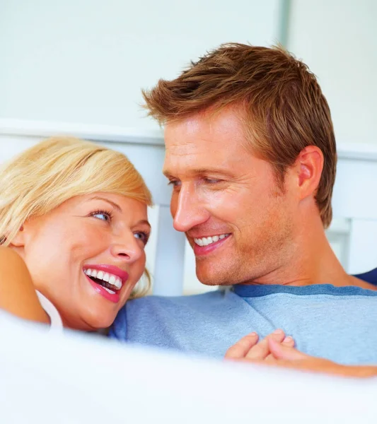 Cheerful middle aged couple looking at each other. Portrait of a cheerful middle aged couple looking at each other
