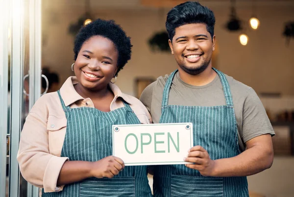 Portrait, couple and open sign by small business owners happy at coffee shop, cafe and support together. Team, restaurant and black people smiling due to startup growth and proud of success or vision.