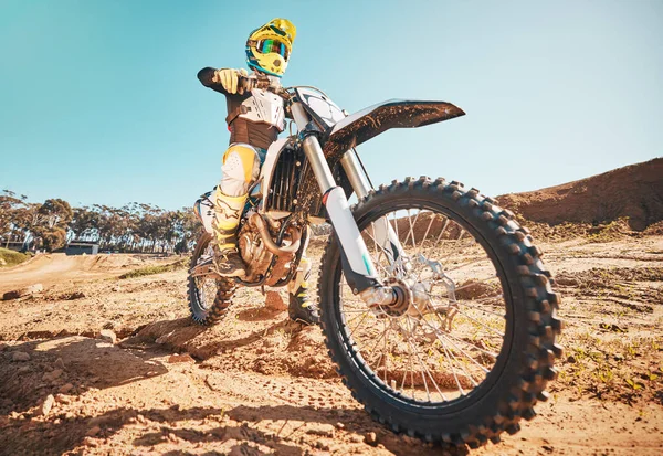 Motorcross, motorcyclist and man in sports gear for challenge, offroad race and desert rally. Driver, bike and ready for dirt track competition, motorbike performance and action on adventure course.