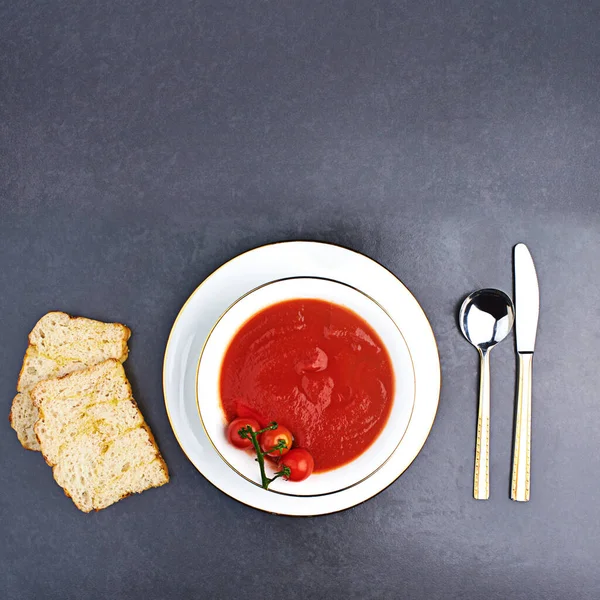 Theres nothing tomato soup cant fix. High angle studio shot of delicious soup and bread on a table