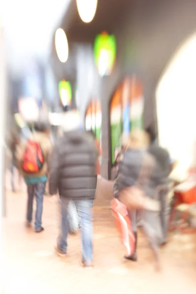 Motion blurred city life. Motion and lens blurred photo of city people