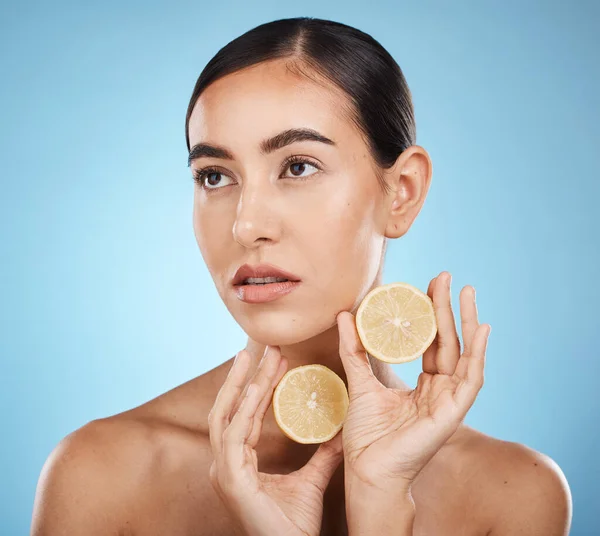 Lemon skin care, beauty and woman with vitamin c for dermatology, natural cosmetics and wellness. Aesthetic model person for sustainable facial glow, nutrition and detox for face on blue background.