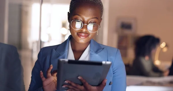 Black woman, tablet and business in office at night working overtime, corporate deadline or online research. Social media, internet surfing and female from Nigeria on digital tech in dark office