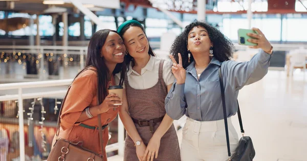 Selfie, friends and social media with woman together posing for a photograph in a mall or shopping center. Phone, social media and smile with a happy female friend group taking a picture for fun.
