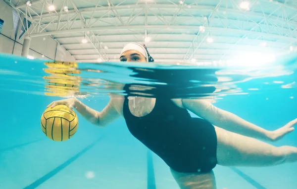 Water polo, sports and woman in swimming pool for game, competition and match practice. Professional sport, fitness and girl athlete below aqua surface with ball for training, exercise and workout.