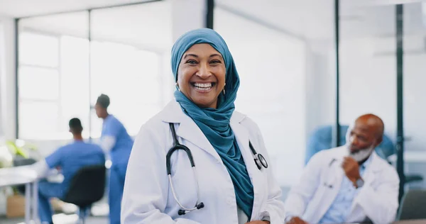 Face, Islamic woman and doctor with smile, hospital and confidence for surgery, consulting and smile. Muslim female, lady and medical professional for healthcare, consultant and surgeon in clinic