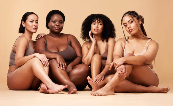 Body, diversity and portrait of natural women group together for inclusion, beauty and power. Aesthetic model people or friends on beige background with skin glow, pride and motivation for self love.