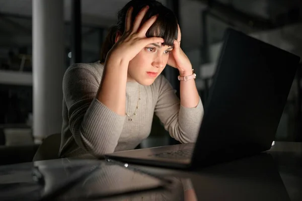 Laptop, cybersecurity or woman with stress, anxiety or worry from bad mistake or problem online. Data problem, 404 error or frustrated worker stressed by a financial loss on screen at night in office.