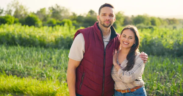 Agriculture, farm and portrait of eco friendly couple standing in sustainable, green and agro field. Sustainability, farming and happy woman and man on outdoor eco adventure together in countryside