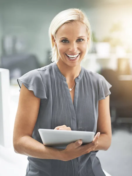 Work smarter, not harder. Portrait of a businesswoman holding a digital tablet