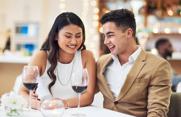 Love, couple and in restaurant with smile, celebration and quality time together, happiness and affection. Romance, man and woman with fine dining, wine glasses and romantic with bonding and loving.
