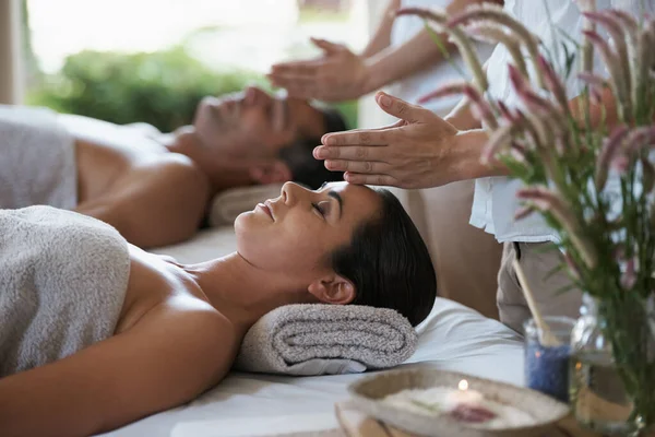 Transferring healing energy. a mature couple enjoying a relaxing massage