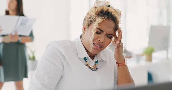 Woman, stress headache and frustrated at office desk for deadline anxiety, employee burnout and mental health depression. Black woman, sad and business frustration or tired corporate worker in pain.