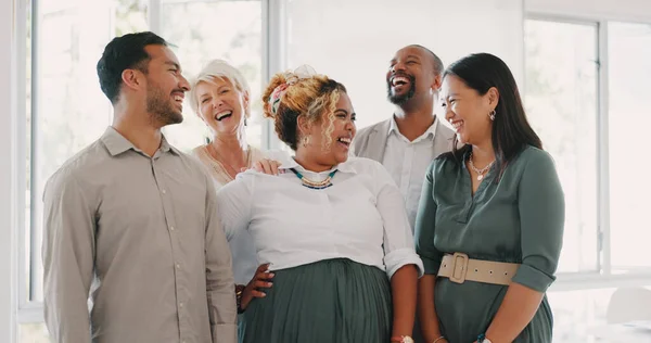 Success, happy or funny business people in an office building laughing at a funny joke after a group meeting. Diversity, comic or employees with big smiles bonding after a successful business deal.
