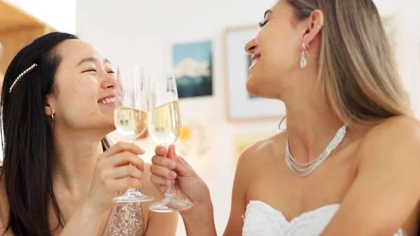 Wedding, bride and toast with a woman and her bridesmaid drinking champagne before a marriage ceremony or celebration event. Glass, cheers and celebrating with a young female laughing with a friend.