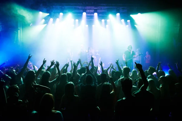 Music, dance and party with crowd at concert for rock, live band performance and festival show. New year, celebration and disco with audience of fans listening to techno, rave and nightclub event.
