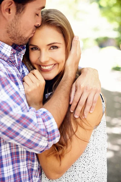 Couple, portrait or forehead kiss hug in garden, nature or park on valentines day date, romance or bonding love. Smile, happy woman or man in embrace, relax support or partnership for profile picture.