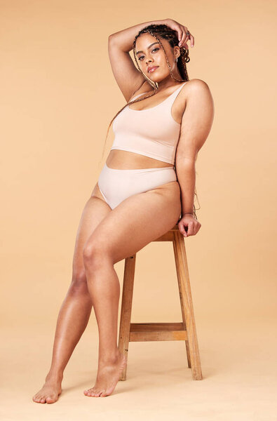 Woman in portrait with underwear, plus size and body positivity, fitness and beauty with skin isolated on studio background. Health, wellness and person with nutrition, cellulite and dermatology.