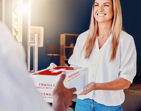 Woman, medicine or receiving courier box in house or home from medical supply chain, logistics or healthcare ecommerce. Smile, happy or customer and deliveryman parcel, retail pills or wellness cargo.