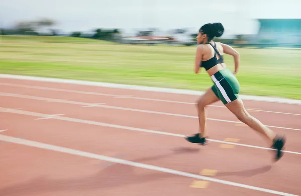 Black woman, running and athletics for sports training, cross fit or exercise on stadium track in the outdoors. African American female runner athlete in fitness, sport or run for practice workout.