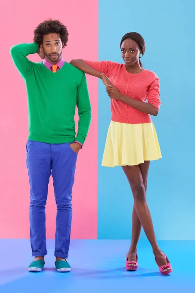 I know whats best. Studio shot of a young couple standing against a colourful background