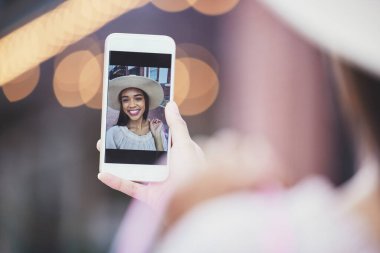 Phone selfie, fashion and woman on screen for social media update, live streaming or online shopping tips in bokeh. Smartphone of influencer, person or gen z user on profile picture or video call app.