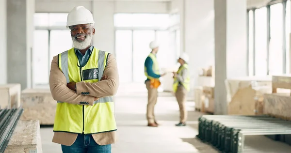 Senior black man, architect and business construction with crossed arms for building industry on site. Portrait of a confident elderly African male engineer, builder or architecture at the workshop.